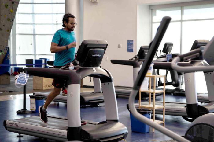 A male member running on the treadmill.